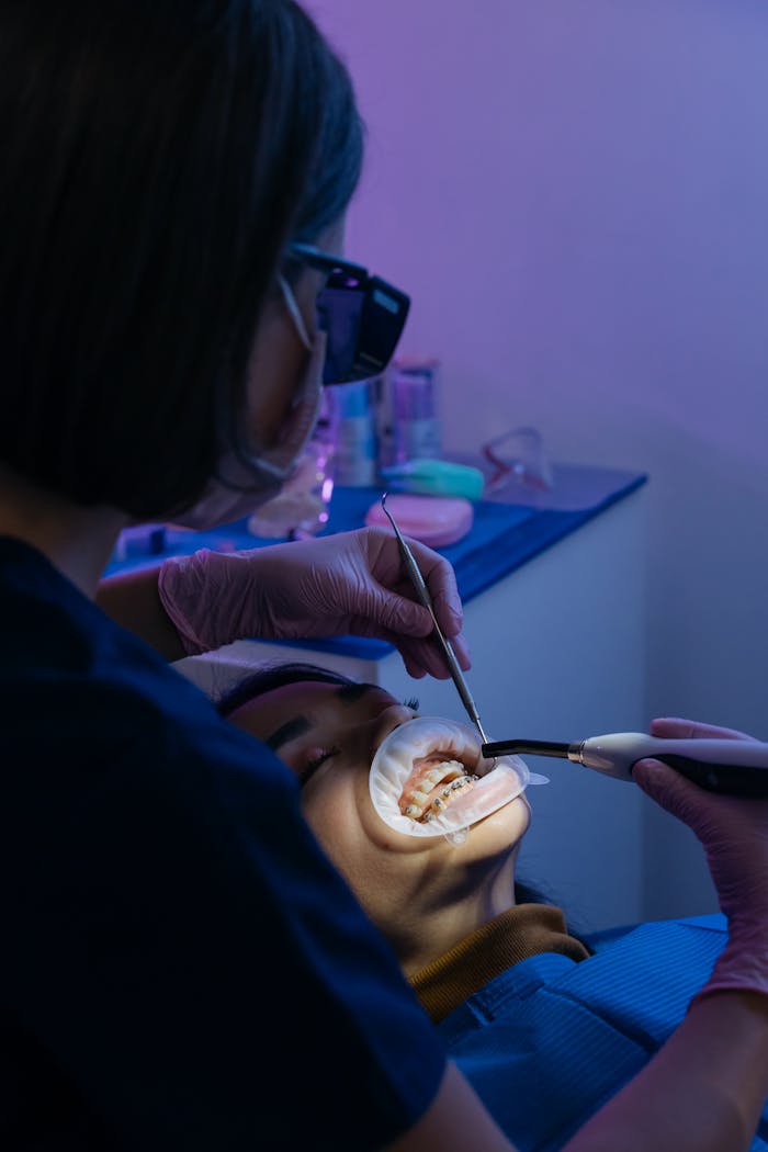 Mastering the First Impression: Your intriguing post title goes here A dentist performing a dental procedure on a patient in a modern clinic setting.